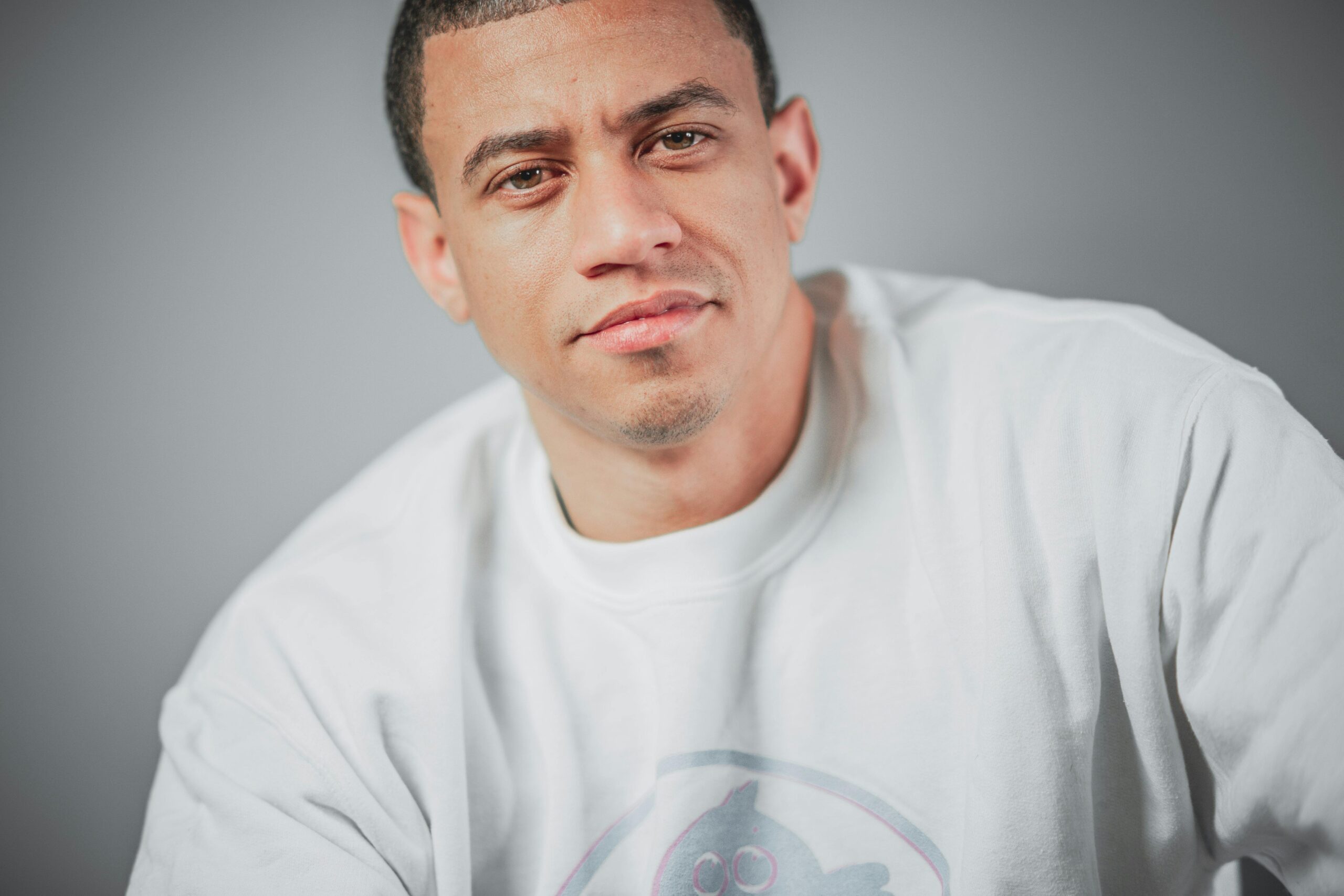 Close-up portrait of an adult male in casual wear, with a serious expression.
